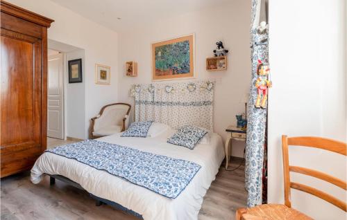 a bedroom with a bed with blue and white sheets at 2 Bedroom Gorgeous Home In Jonquires St Vincent in Jonquières-et-Saint-Vincent