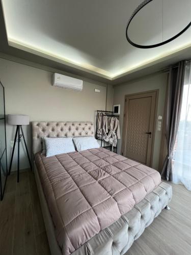 a bedroom with a large bed in a room at OMG in Agia Pelagia