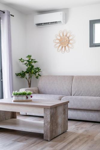 a living room with a couch and a table at Charmante Maison entre Cannes et Nice in Le Bar-sur-Loup