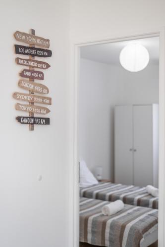 two beds in a room with a mirror at Charmante Maison entre Cannes et Nice in Le Bar-sur-Loup