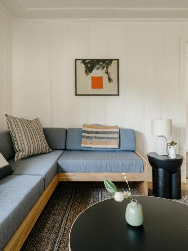 a living room with a blue couch and a table at Dawn Ranch in Guerneville