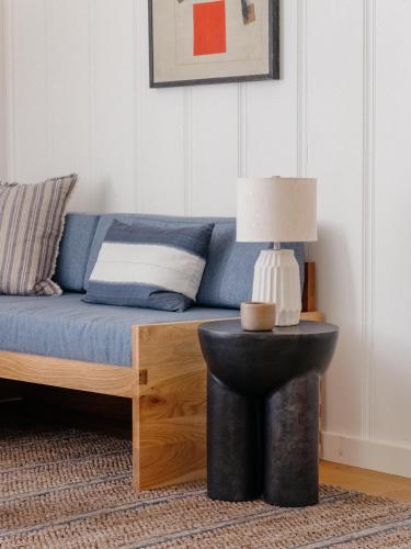 a living room with a couch with a lamp on a table at Dawn Ranch in Guerneville