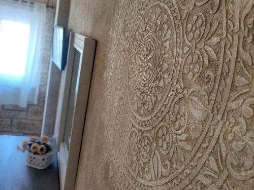 a wall with a design on it in a room at Grotta dei Puntali B&B in Carini