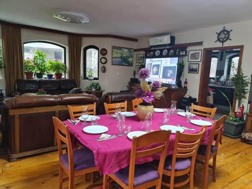 a dining room with a table with a purple table cloth at Villa Janet in Dolna Banya