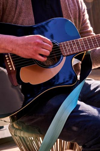 a man is playing a black acoustic guitar at Dawn Ranch in Guerneville