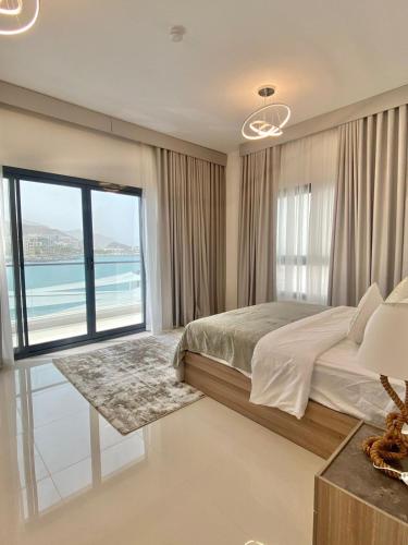 a bedroom with a bed and a view of the ocean at The Pearl Villa 5 bedrooms with pool Sea and Mountain View in Fujairah