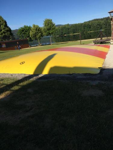 a skate park with a yellow and red curb at Papeto in Frymburk