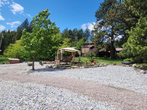 a gravel yard with a gazebo and trees at Whitebird Summit BNB in Whipsaw Saddle