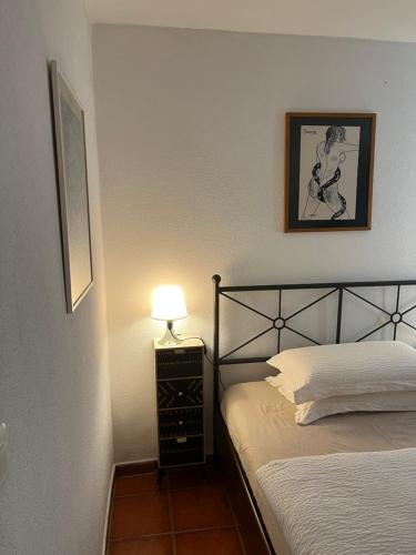 a bedroom with two beds and a lamp on a night stand at CASA STEFANIA con giardino a LUGANO in Grancia