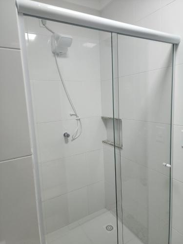 a shower with a glass door in a bathroom at RESERVE SEU FLAT E GANHE SUA DIVERSÃO in Caldas Novas