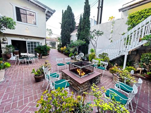 a patio with a table and chairs and a fire pit at Catalina Courtyard Suites in Avalon