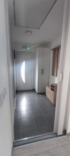 an empty room with a hallway with a door and a tile floor at Perfect Holidays in Vlasic