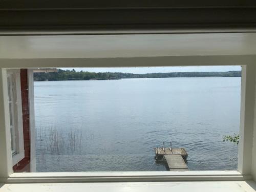 a window with a view of a large lake at Waterfront house with jacuzzi & jetty in Stockholm in Stockholm