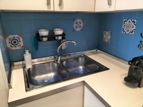 a kitchen sink with a faucet on top of it at Sea Side Attic in Rosolina Mare