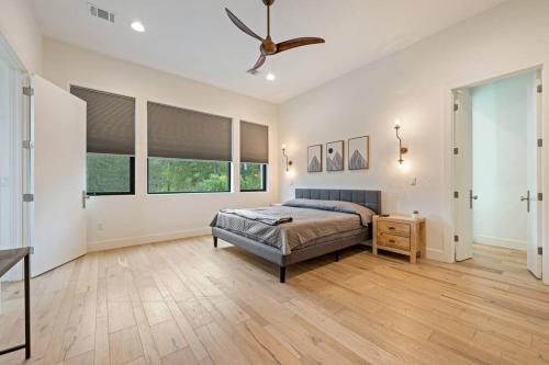 a bedroom with a bed and a ceiling fan at central contemporary w/ POOL and SPA in Austin