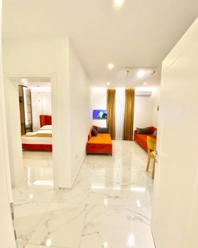 a living room with a couch and a bed at Apartments Oda Hotel in Velipojë