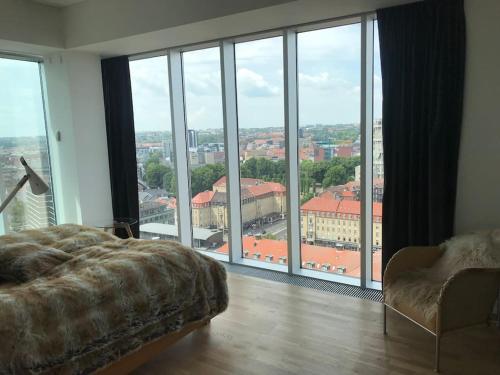 um quarto com uma cama e uma grande janela em Unik udsigt og beliggenhed em Aarhus