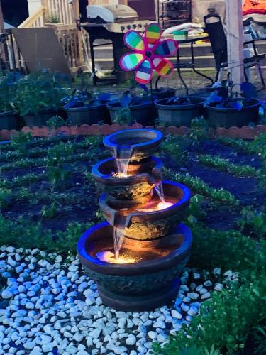 a water fountain in the middle of a garden at Town & Country Motel in Parry Sound