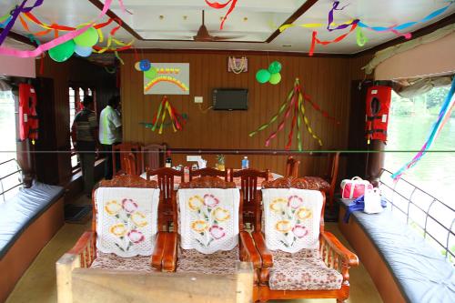 a group of chairs in a room with flags and balloons at Beach Paradise Day Cruise Houseboat in Alleppey