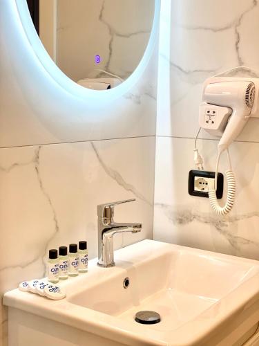 a bathroom with a sink and a mirror at Apartments Oda Hotel in Velipojë