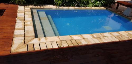 una piscina con una valla de madera alrededor en The Croft Sri Lanka, 