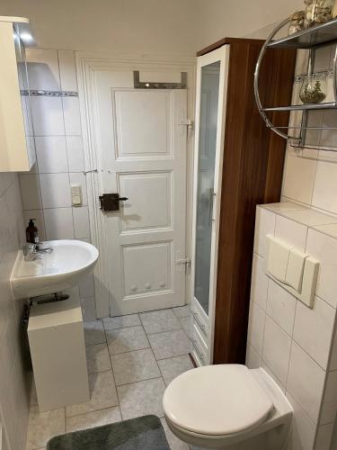 ein Badezimmer mit einem weißen WC und einem Waschbecken in der Unterkunft Ferienwohnung Martina in Blankenburg