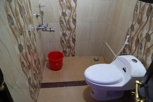 a bathroom with a white toilet and a shower at Beach Paradise Day Cruise Houseboat in Alleppey