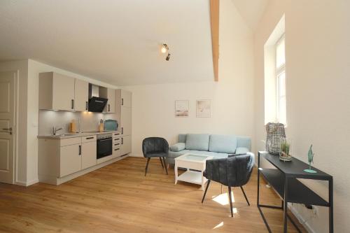 a living room with a couch and a table and chairs at Ferienwohnung Schlei-Suite in Schleswig