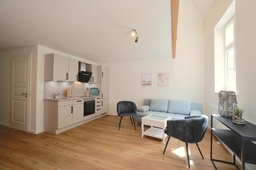 a living room with a couch and a table at Ferienwohnung Schlei-Suite in Schleswig