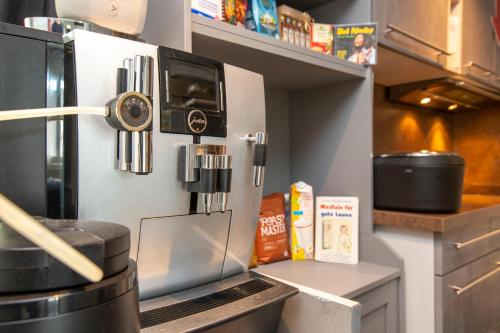 a kitchen with a counter with a stove at BnB Comfort Guesthouse Olten - Lostorf in Lostorf