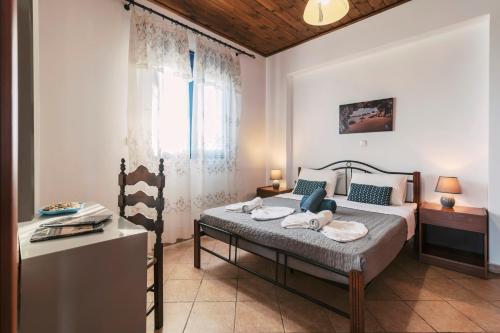 a bedroom with a bed and a window at Villa Deep Blue in Lachania