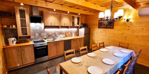a kitchen with a table and chairs in a room at Ośrodek Wczasowy Na Borach in Korbielów