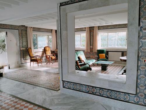 a living room with a mirror on the wall at Dar Soltana in Sidi Daoud