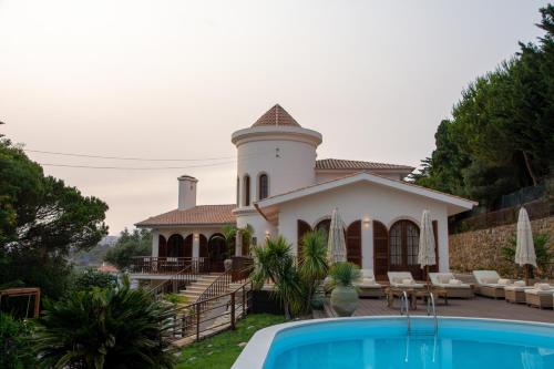 a house with a pool in front of it at Villa Pietra Estoril Eco Guesthouse in Estoril