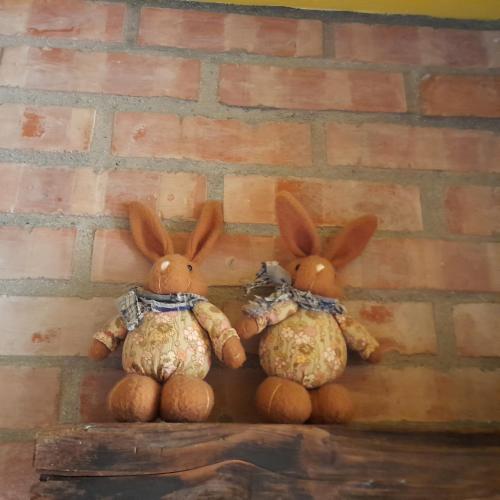 a group of three stuffed rabbits sitting on a wall at 兔窩很Chill in Yilan City