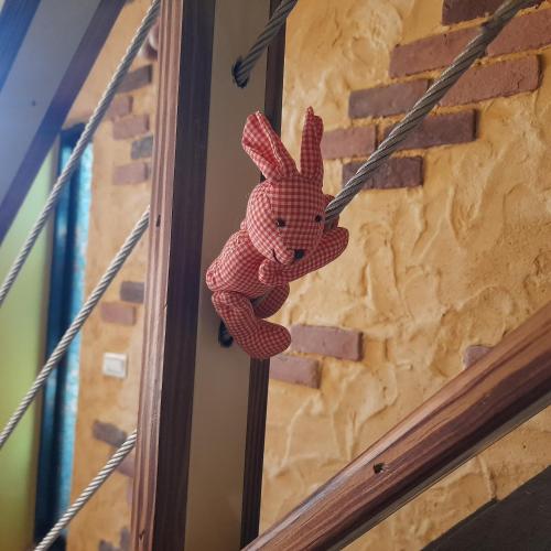 a pink stuffed animal hanging on a wall at 兔窩很Chill in Yilan City