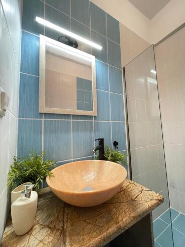 a bathroom with a large wooden bowl sink on a counter at Souzana Suite Leptokarya in Leptokarya
