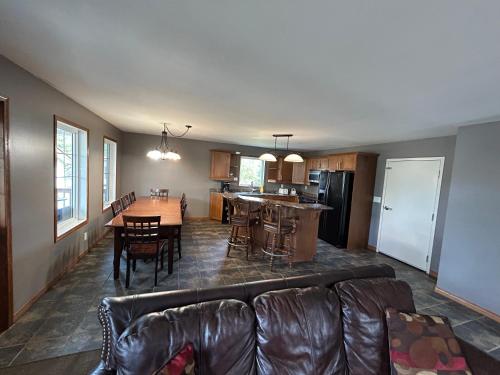 a living room and kitchen with a couch and a table at Betula Lake Resort in Seven Sister Falls