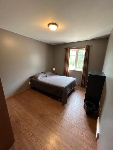 a bedroom with a bed and a television in it at Betula Lake Resort in Seven Sister Falls