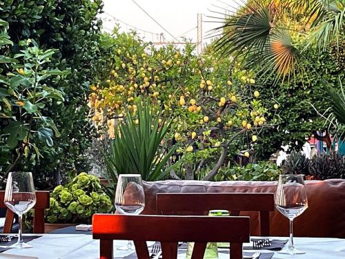 a table with wine glasses on top of it at Hotel Villa A Mare in Rodi Garganico