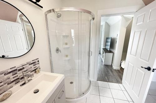 a bathroom with a shower and a sink at Gateway to Greenwich Suites in Saint Peters