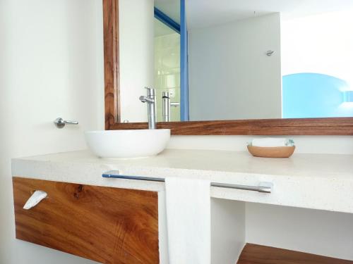 a bathroom with a sink and a mirror at Hotel Suites Villasol in Puerto Escondido