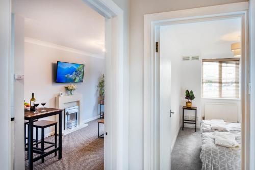a hallway with a living room and a dining room at Train Station Serenity in Staines upon Thames