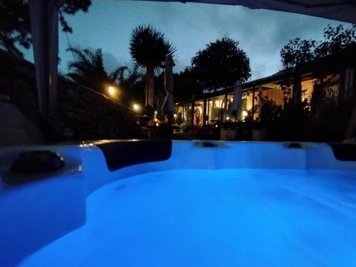 a pool with blue lights in a yard at night at Casa Finca Doñana in Arucas
