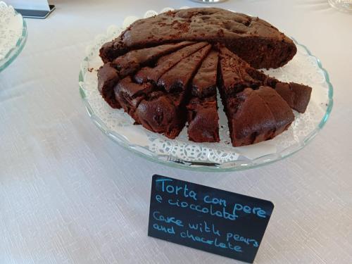 a chocolate cake on a glass plate on a table at BUE MARINO Hotel & Roof Lounge in Cala Gonone