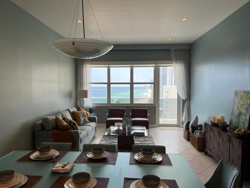 a living room with a couch and a table at Penthouse Beach Front 1st line, 2 BR, 2 BA, New Decoration & Furnitures, unobstructed view of the beautiful Atlantic, free parking in Hollywood