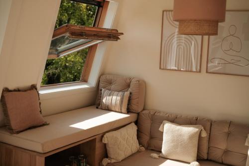 a living room with a couch and a window at Canal View Stay Amsterdam in Amsterdam