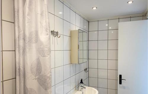 a bathroom with a shower curtain and a sink at Amazing Apartment In Sommen With Kitchen in Sommen