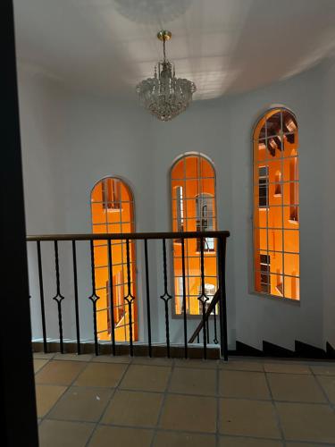 a room with orange windows and a black railing at Hotel Artistico in Bogotá
