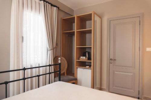 a bedroom with a bed and a book shelf at Kapya Cunda in Ayvalık